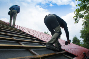 Installing synthetic underlayment for metal roofing installation services